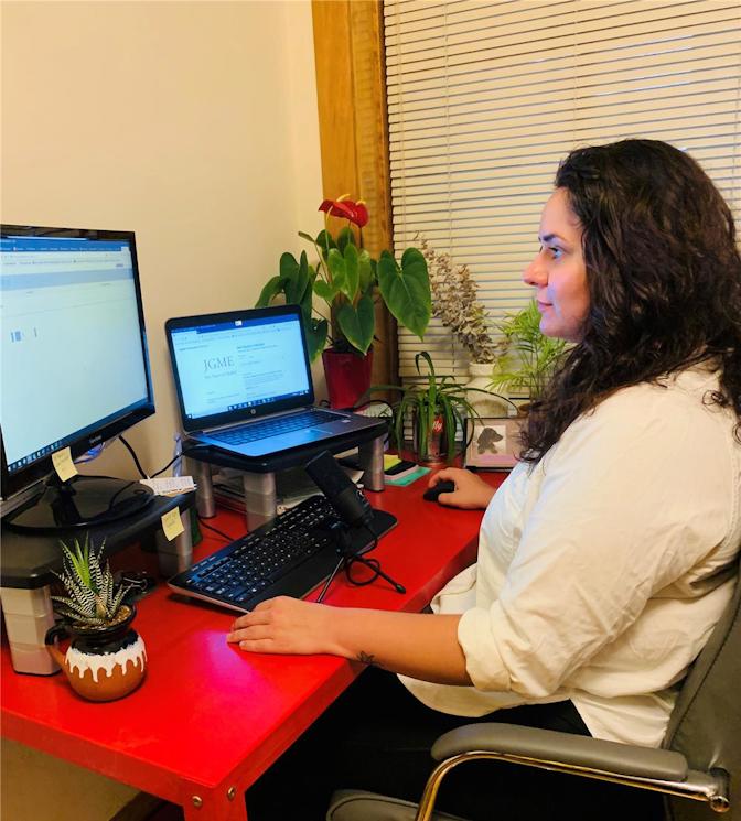 JGME Editorial Assistant Emily Barnash records a podcast episode from her home work station.